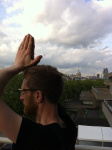 Man demonstrating Utkatasana with St Paul's Cathederal in the background