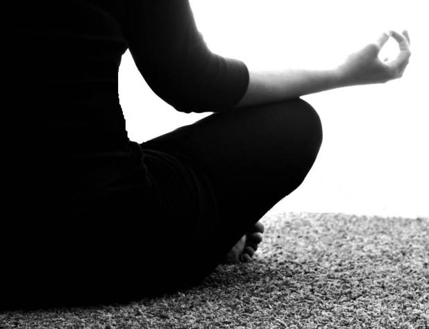 Woman seated holding a mudra