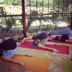 Yoginis practice the Plough pose on the yoga terrace during the Lucyoga and Get Lost Retreats yoga retreat in Spain
