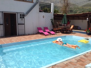 A girl floats in the pool as she relaxes on the Lucyoga and Get Lost Retreats yoga retreat